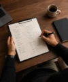Hand writing marketing strategy notes on a clipboard